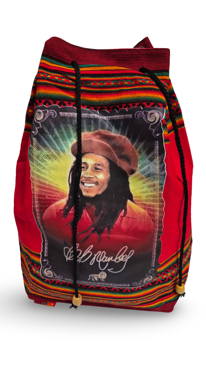 A red drawstring backpack featuring a large graphic print of Bob Marley on the front, with a colorful red, yellow, green, and black patterned border and black cords with wooden beads.