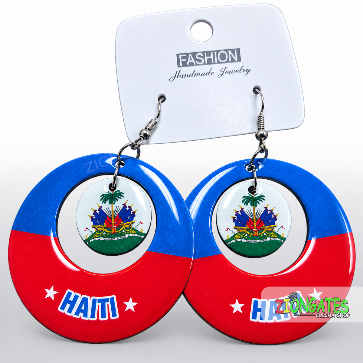 A pair of large circular dangle earrings featuring the Haiti flag design, with a small Haiti coat of arms medallion in the center of each earring. The earrings are blue and red with white stars and the word 'HAITI' printed at the bottom.