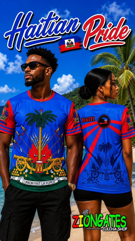 A man and a woman modeling matching Haitian pride graphic t-shirts on a tropical beach. The t-shirts are bright blue with red sleeves and a central graphic featuring a palm tree, cannons, and the Haitian flag, ZIONGATES Culcha Shop.