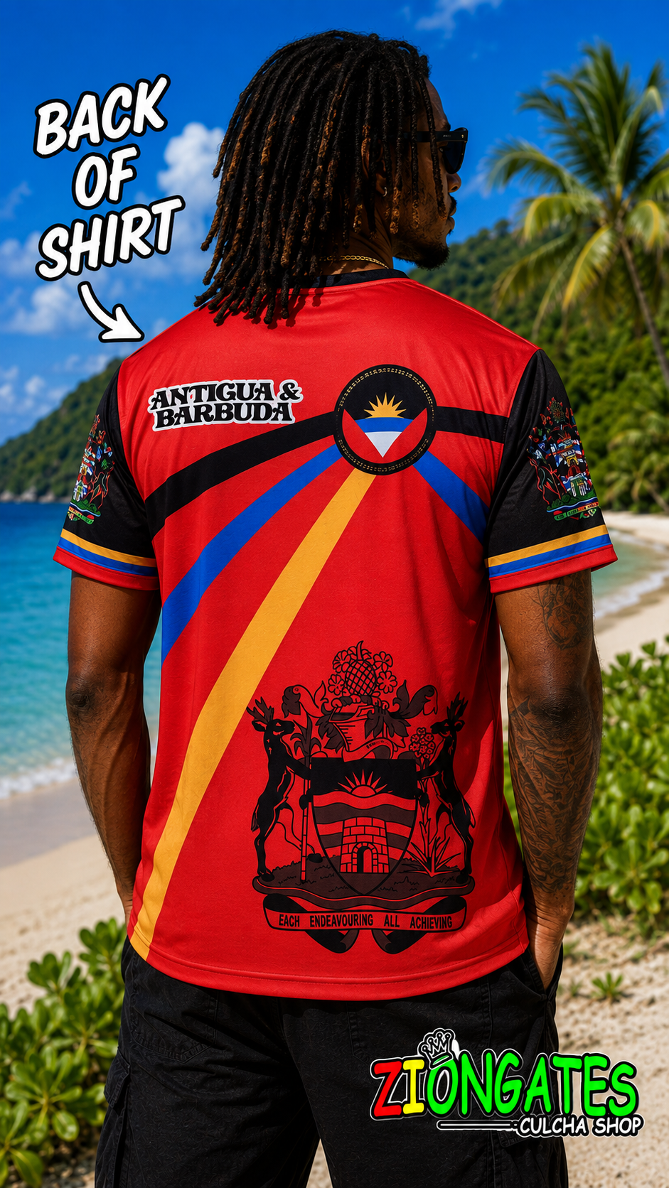 A man shown from the back wearing a red and black Antigua & Barbuda athletic t-shirt with a graphic print, set against a tropical beach background. 