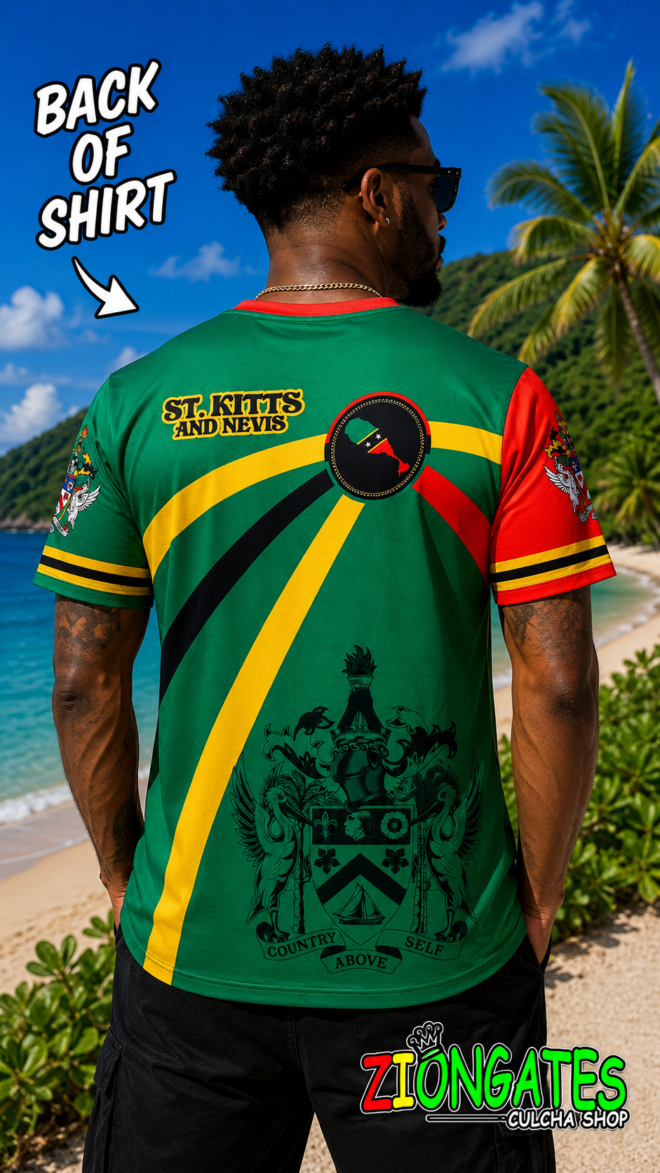 A man shown from the back wearing a green, yellow, and red St. Kitts and Nevis graphic t-shirt on a tropical beach.