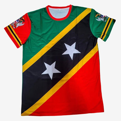 A short-sleeve crewneck t-shirt featuring the flag of Saint Kitts and Nevis, with its distinctive diagonal black band, two white stars, and red, green, and yellow colors. The shirt is displayed flat against a light gray background.